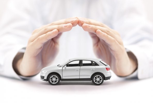 extended car warranty services hands holding protecting toy car  
